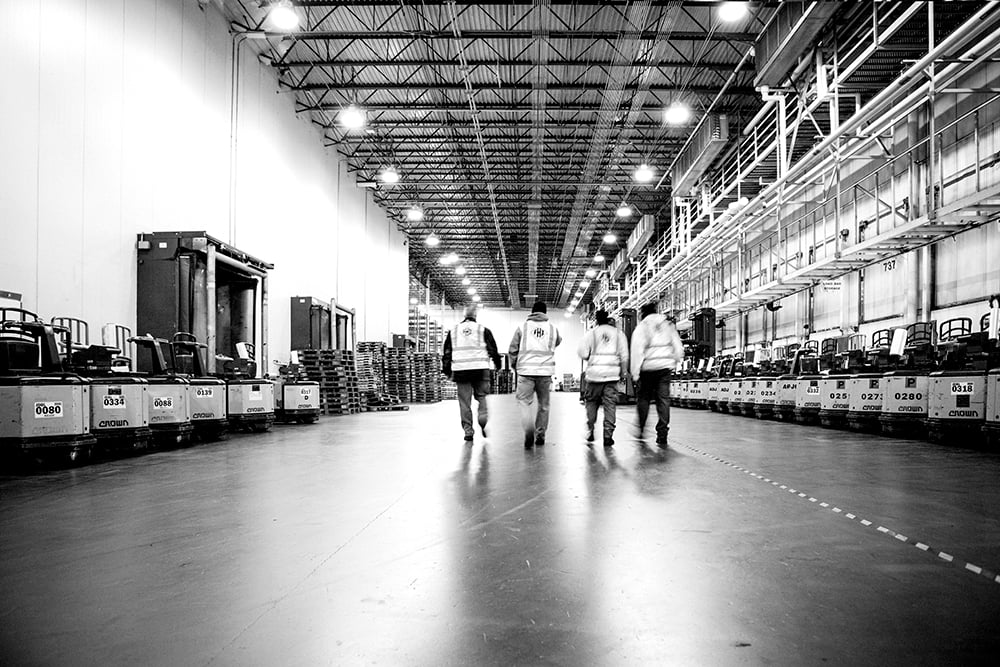 FHI Employees Walking Through Warehouse