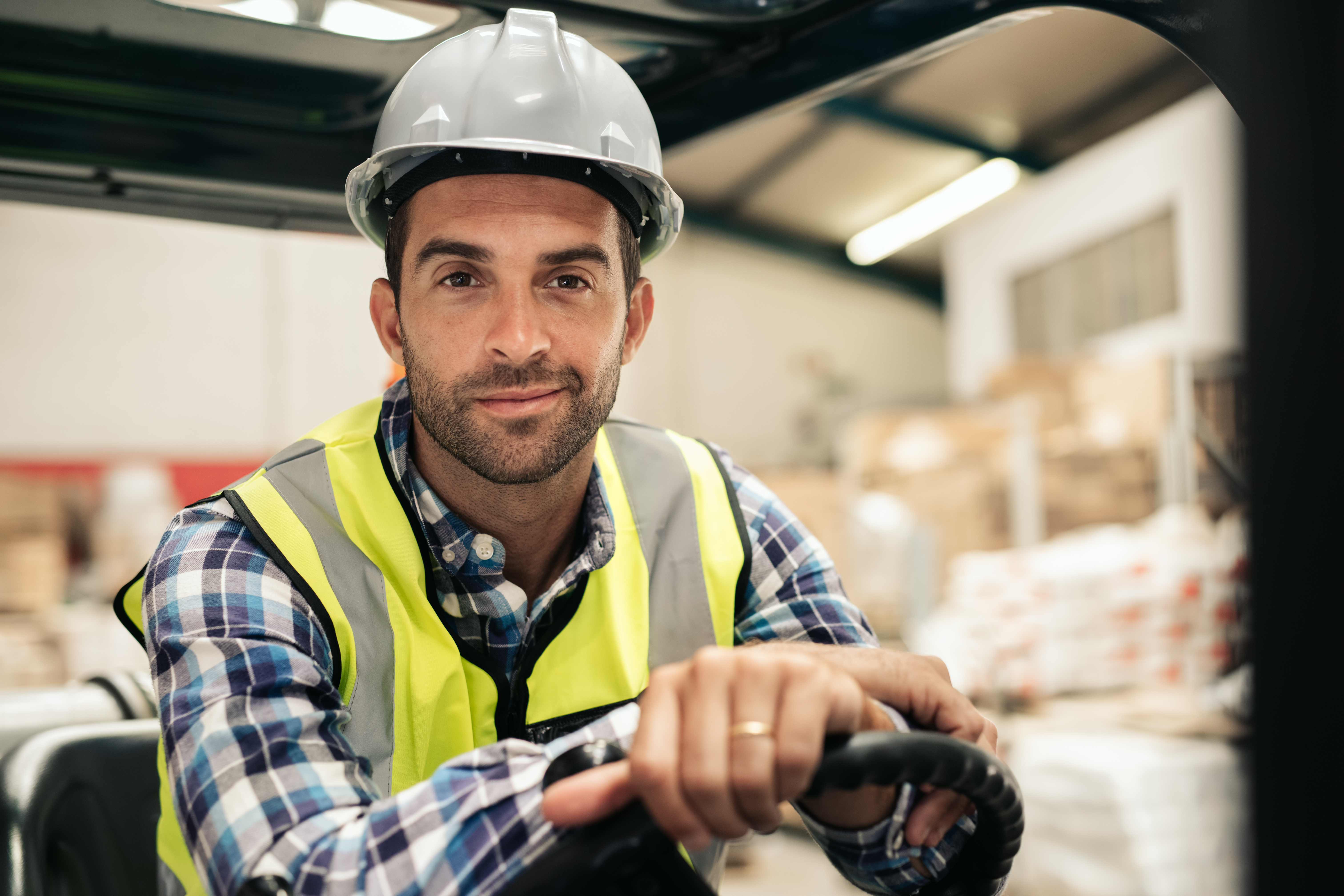 An image of a warehouse worker sitting on a forklift who is part of a professional lumper service.